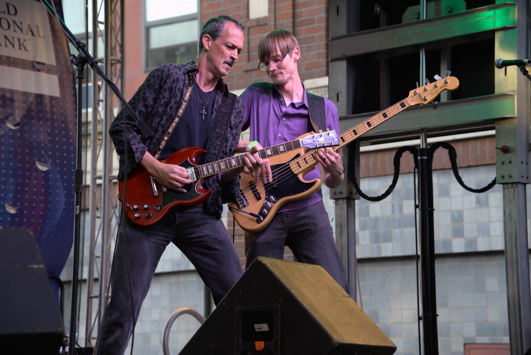 Jason Wells playing guitar during a live performance